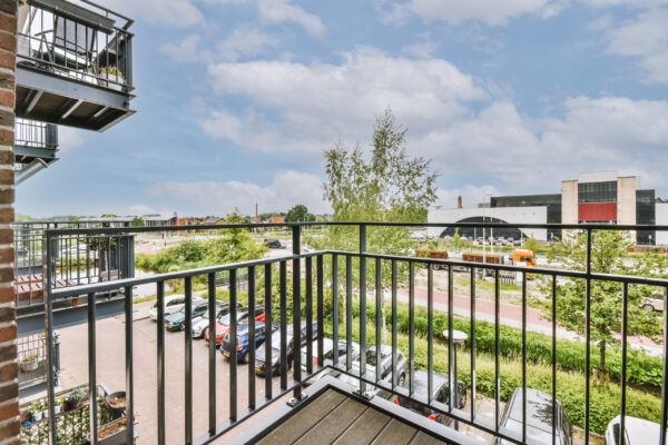 Narrow brick balcony with metal railings and door